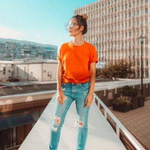 a girl posing in orange tshirt